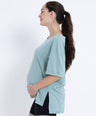 Pregnant woman wearing Breezy-Comfort™ maternity t shirt in light blue with stretchy, breathable fabric and loose fit